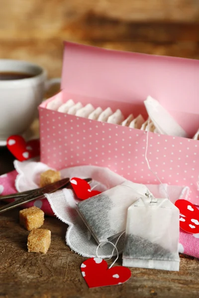 Heart shaped teabag tags and box on wooden background — Stock Photo, Image