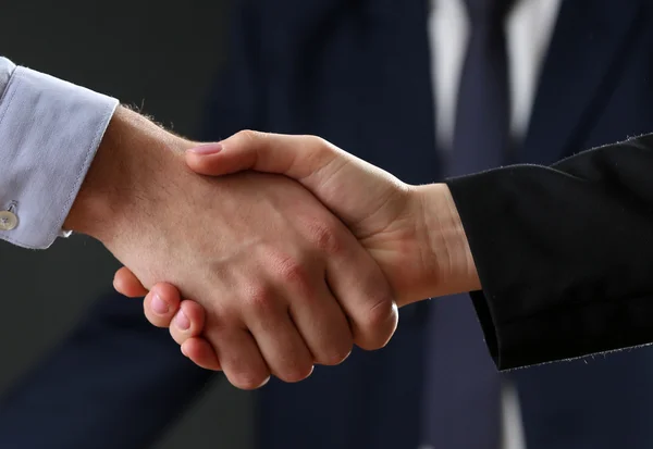 Business handshake on dark background — Stock Photo, Image