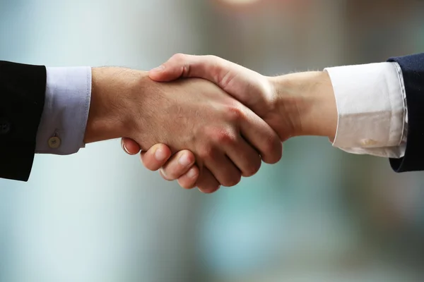 Business handshake on bright background — Stock Photo, Image