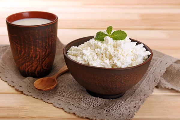 Cottage cheese in bowl with cup of milk on wood background — Stok Foto