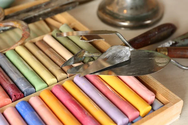 Colorful chalk pastels in box with palette knifes close up — Stock Photo, Image