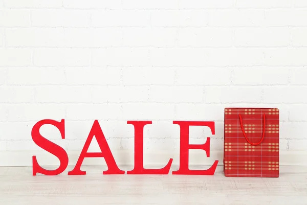 Sale with bag on floor on bright background — Stock Photo, Image