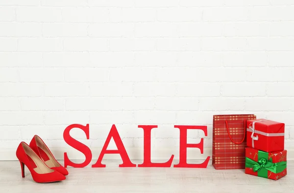 Sale with gifts on floor on bright background — Stock Photo, Image