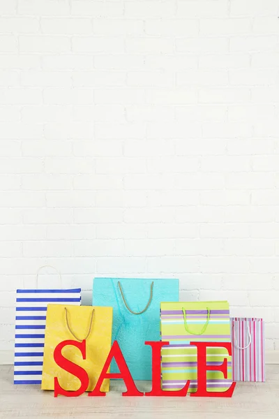 Sale with bags on floor on bright background — Stock Photo, Image