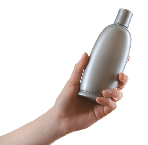 Weibliche Hand mit Kosmetikflasche isoliert auf weiß — Stockfoto