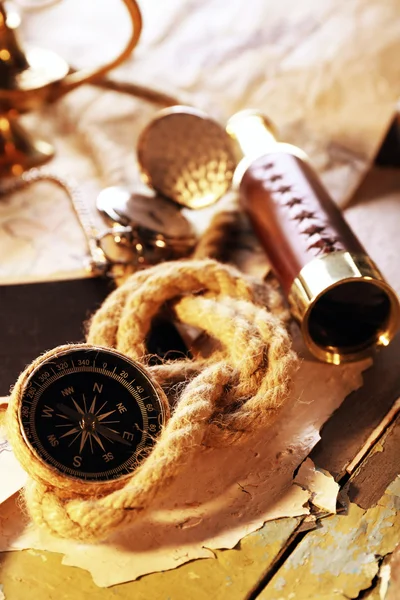 Marine still life spyglass and world map on old wooden background — Stock Photo, Image