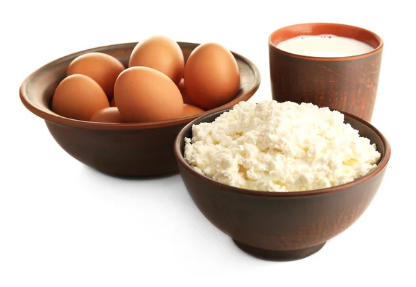 Cottage cheese, milk and eggs in pottery isolated on white — Stock Photo, Image