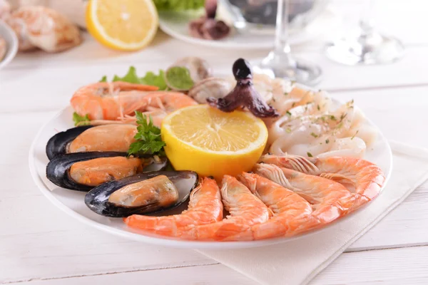 Tasty seafood on plate on table close-up — Stock Photo, Image