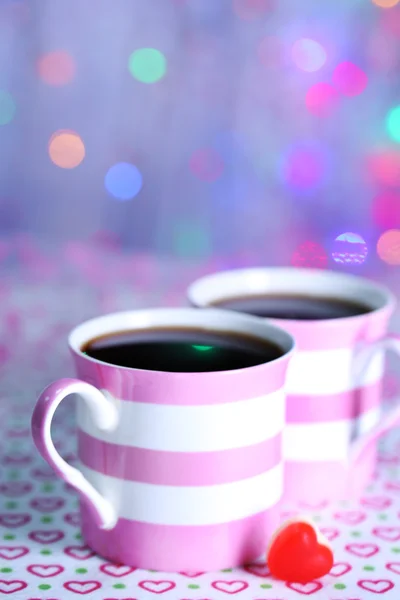 Two cups on table on lights background — Stock Photo, Image