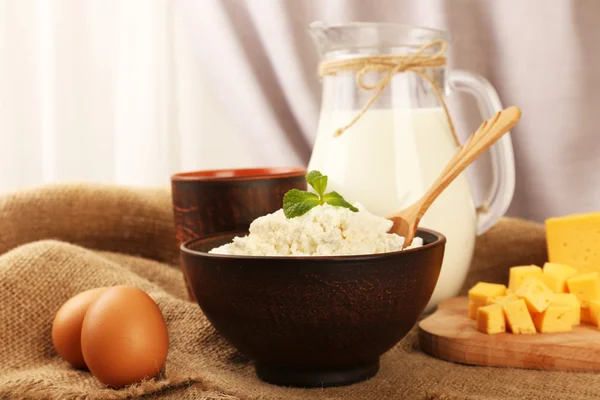 Tasty dairy products on table on fabric background — Stock Photo, Image