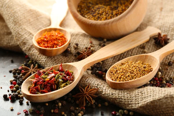 Different kinds of spices on wooden background — Stock Photo, Image