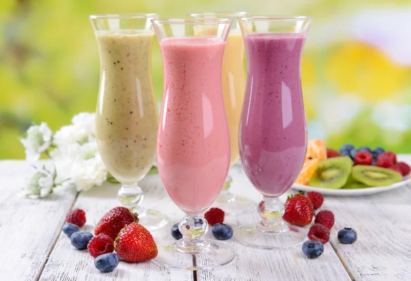 Delicious berry cocktails on table on bright background — Stock Image Delicious berry cocktails on table on bright background Stock Picture
