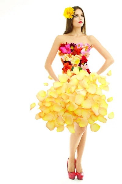 Mulher bonita em vestido feito de flores e pétalas de flores isoladas em branco — Fotografia de Stock