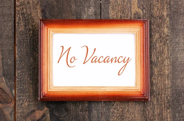 No Vacancy text in frame on wooden background — Stock Photo, Image