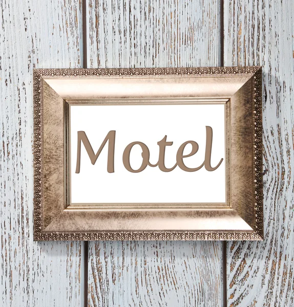 Word Motel in frame op houten achtergrond — Stockfoto