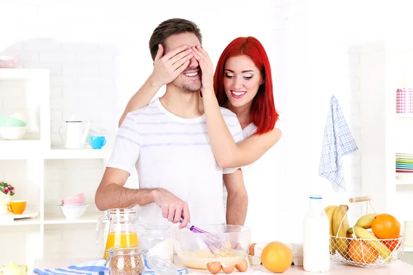 Happy couple preparing dough baking in kitchen — Stock Photo, Image