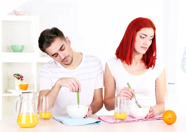 Sleepy couple has breakfast in kitchen — Stock Photo, Image