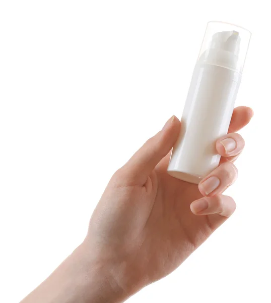 Mano femminile con bottiglia di cosmetici isolata su bianco — Foto Stock