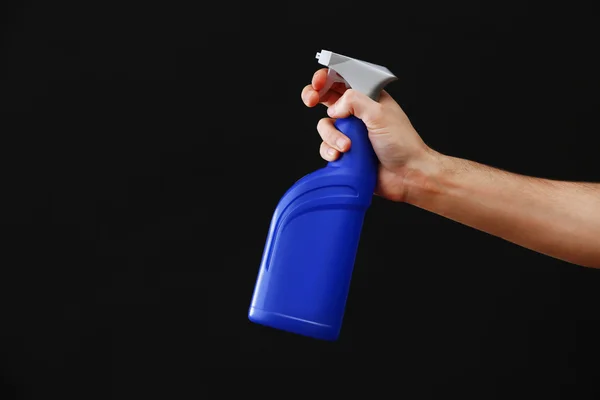 Male hand with sprayer on black background — Stock Photo, Image