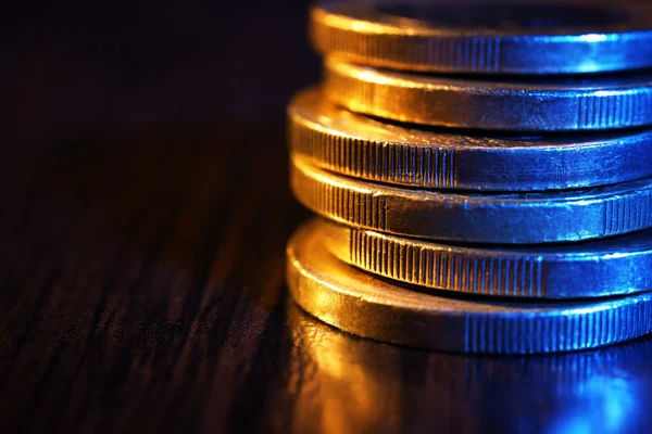 Heap of coins on wooden table, macro view — Stock Photo, Image