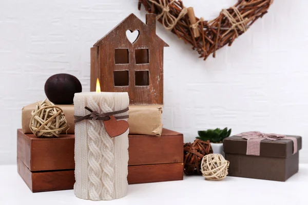 Romantic still life with wicker heart and design details on shelf and white wall background — Stock Photo, Image