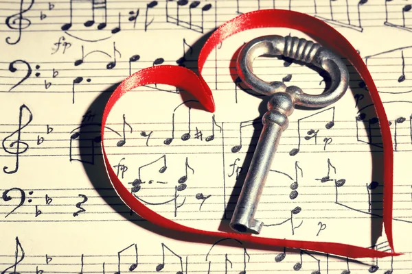 Retro key with heart on music book background — Stock Photo, Image