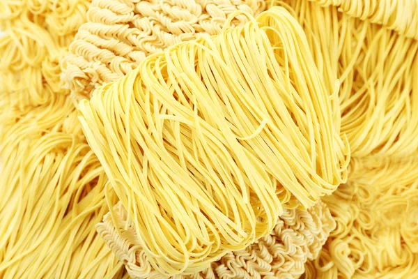 Different dry instant noodles close-up background — Stock Photo, Image