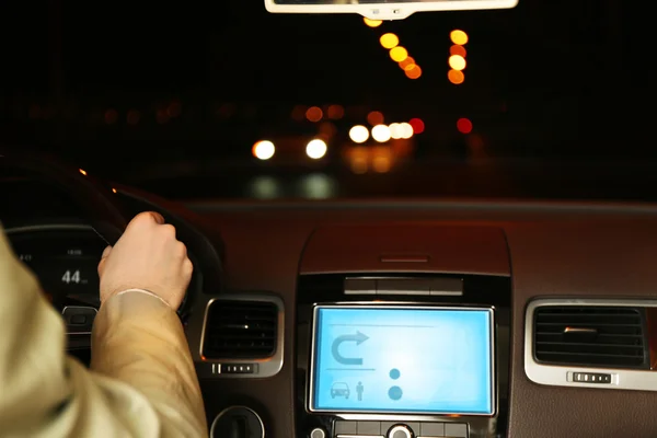 Man driving his modern car at night in city, close-up — Stock Photo, Image