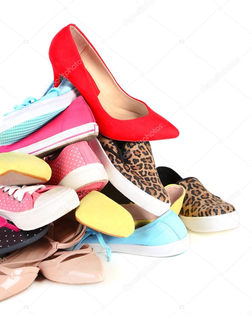 Pile of various female shoes isolated on white