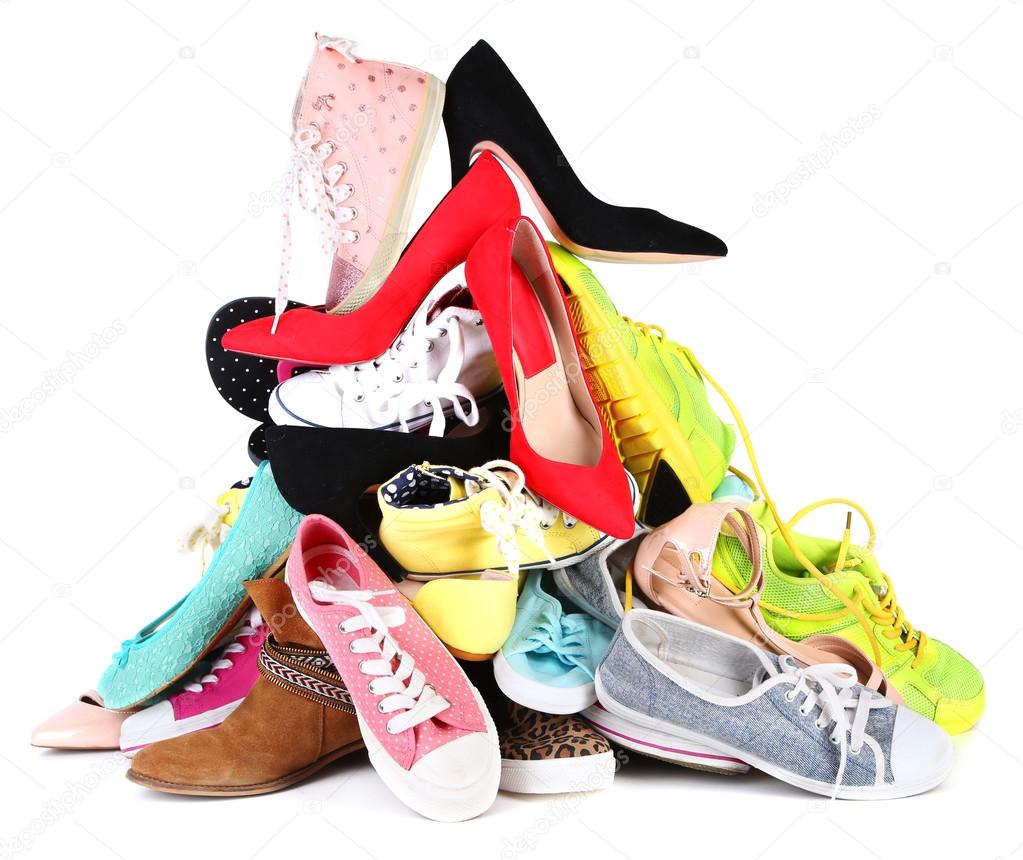 Pile of various female shoes isolated on white