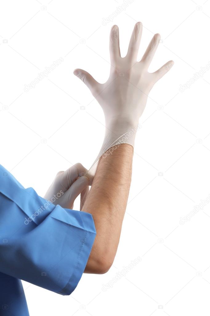 Doctor hand putting on sterile gloves isolated on white