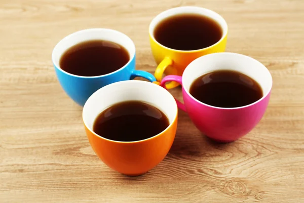 Cups of coffee on wooden table background — Stock Photo, Image