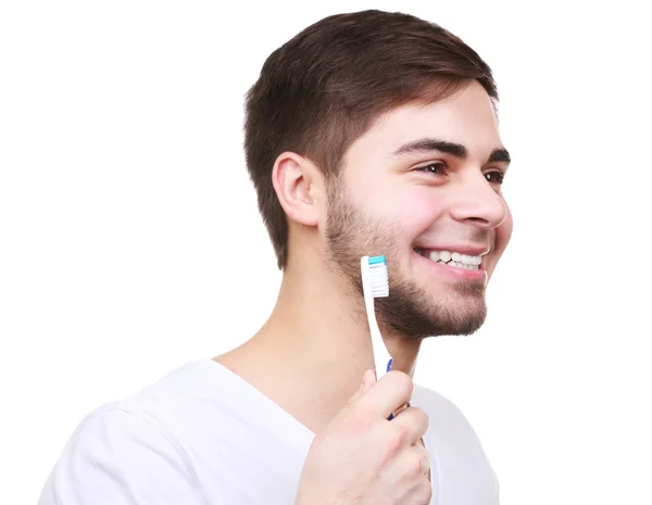 Elinde beyaz izole diş fırçası ile genç adam portresi — Stok fotoğraf