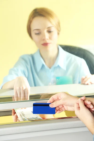 Teller window with working cashier — Stock Photo, Image