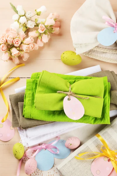 Napkin with Easter decorations  on color wooden background — Stock Photo, Image