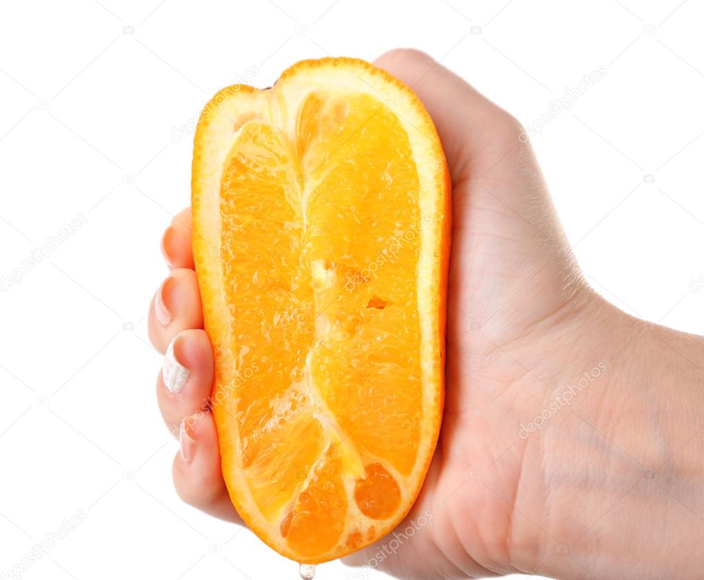 Female hand squeezing orange isolated on white