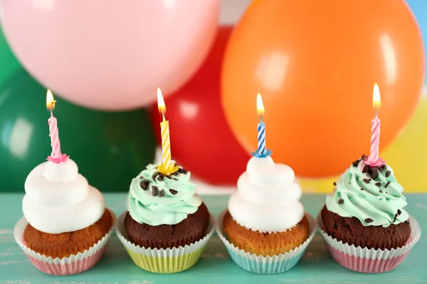 Delicious birthday cupcakes on table on bright background — Stock Photo, Image