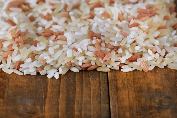 Different types of rice on wooden background — Stock Photo, Image
