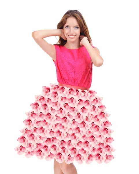 Vacker ung kvinna i klänning gjord av blommor isolerad på vit — Stockfoto