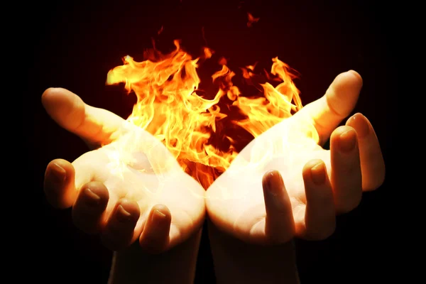 Hands with fire isolated on black — Stock Photo, Image