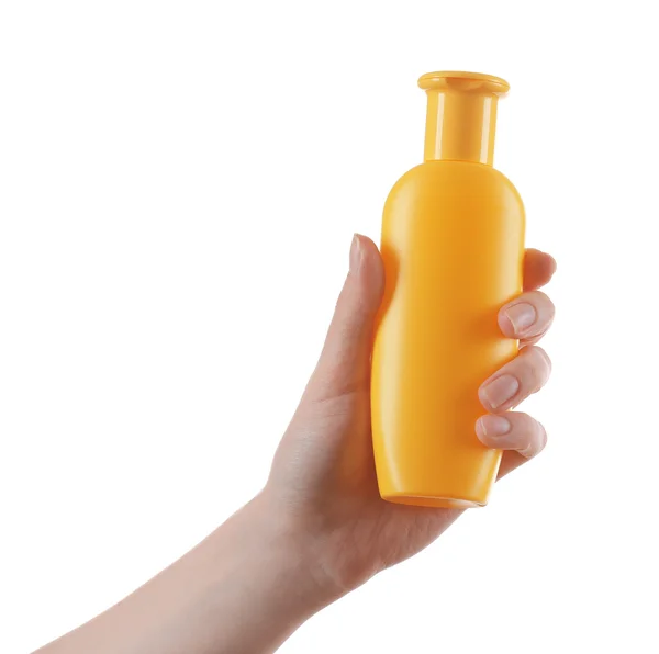 Женская рука с бутылкой косметики — стоковое фото
