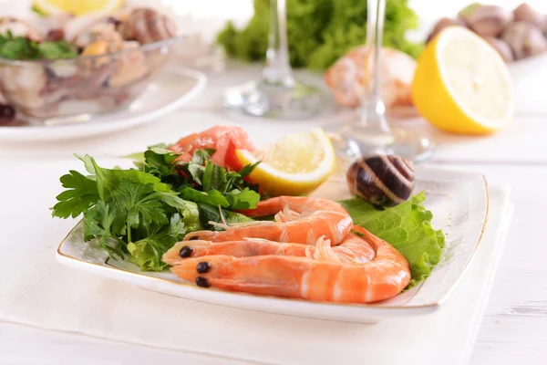 Tasty seafood on plate on table close-up — Stock Photo, Image