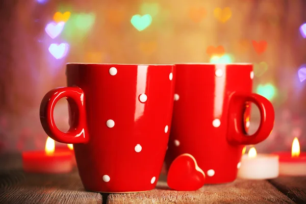 Two red cups on table on lights background — Stock Photo, Image