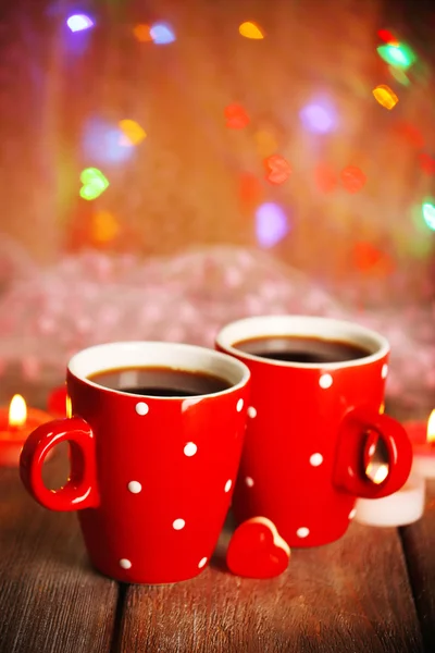 Two red cups on table on lights background — Stock Photo, Image