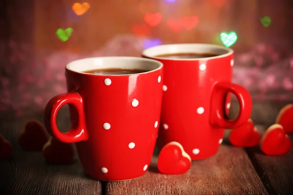 Two red cups on table on lights background — Stock Photo, Image