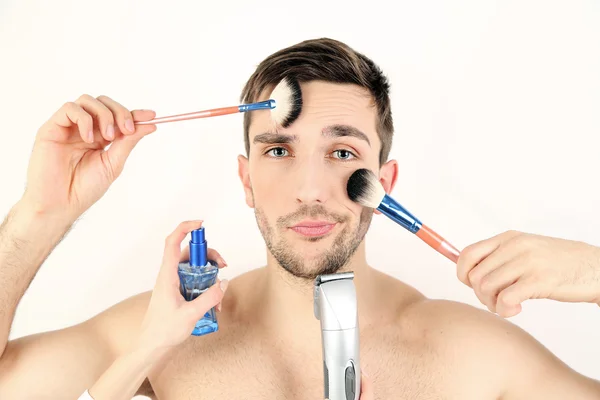 Female hand doing make up young man isolated on white — Stock Photo, Image