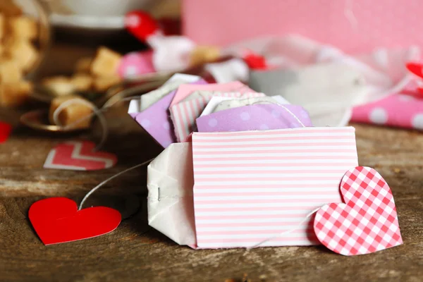 Heart shaped teabag tags on wooden background — Stock Photo, Image