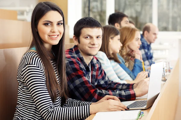 Group of students using gadgets in classroom — Stock Photo, Image