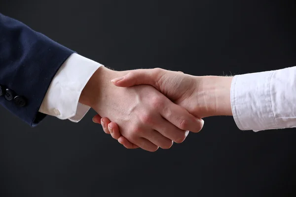 Business handshake on dark background — Stock Photo, Image