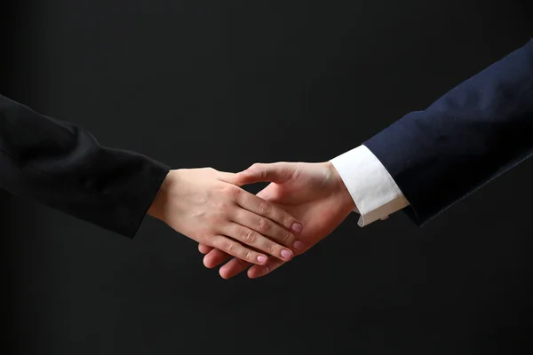 Business handshake on dark background — Stock Photo, Image